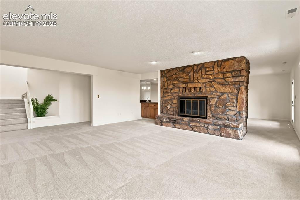 Image 27 of 49: Spacious open-concept living area featuring light wood-finish flooring, rec