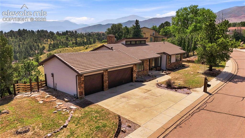 Image 41 of 49: Single-level property featuring a multi-tone tile roof, stone and stucco ex