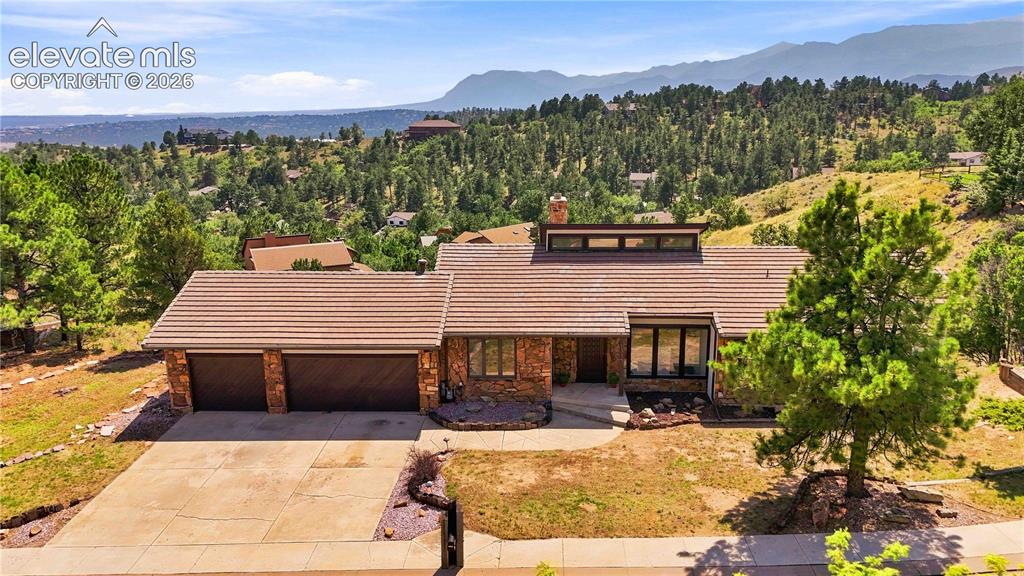 Image 42 of 49: Striking contemporary ranch home showcasing a dual-garage entry, expansive