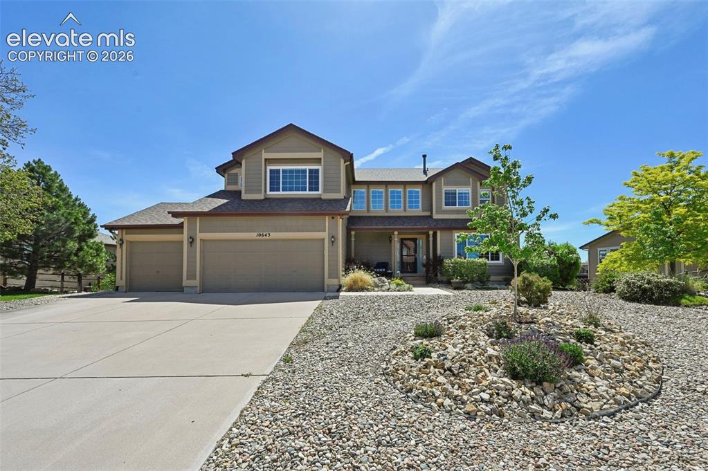 Caption: Contemporary two-story residence featuring a neutral-toned exterior, a concrete driveway, and an att