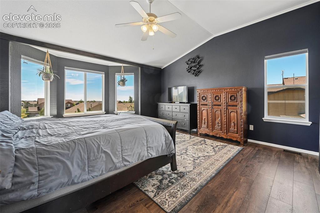 Image 14 of 36: Vaulted ceiling room featuring a bay window with multiple panes, wood-finis
