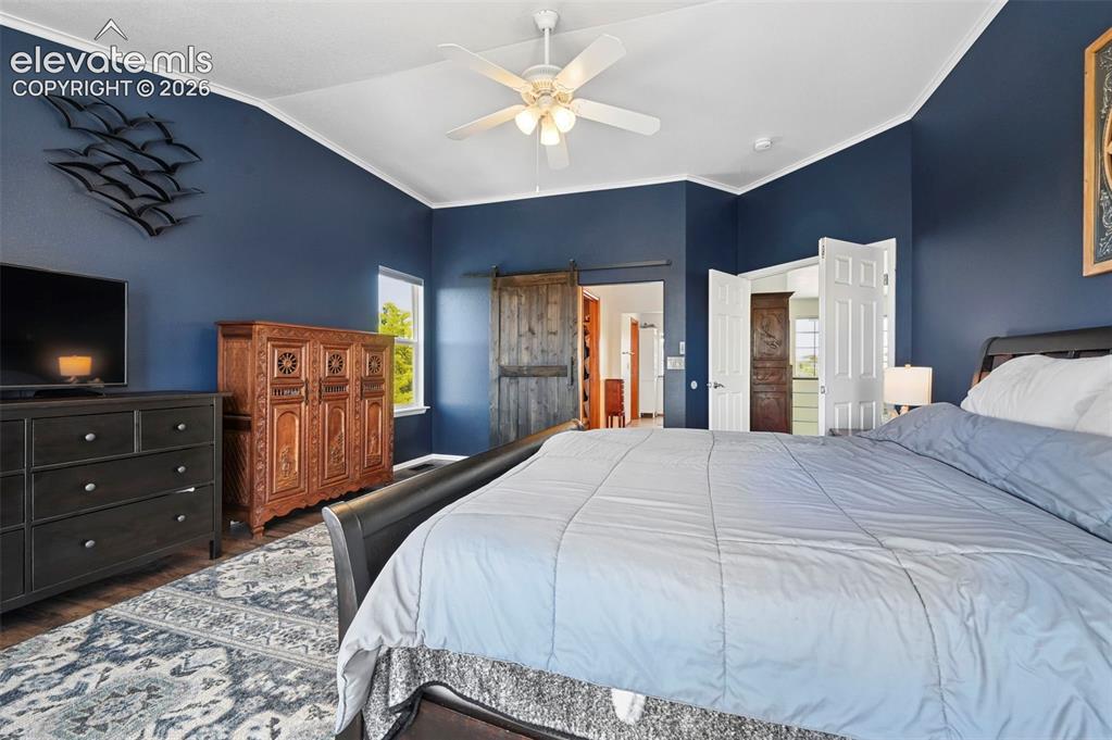 Image 15 of 36: Tray ceiling with crown molding and ceiling fan