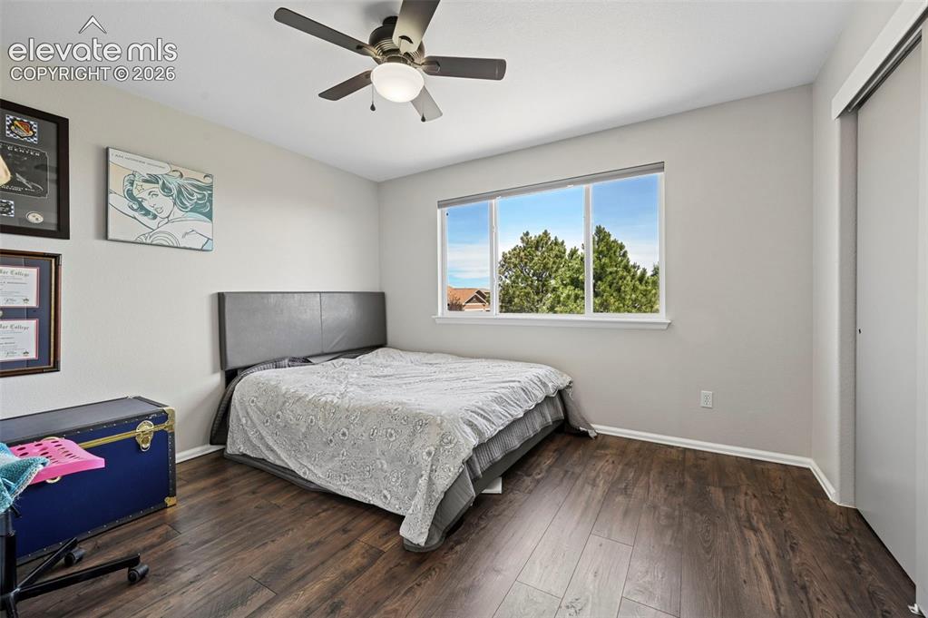 Image 18 of 36: Bedroom featuring wood-finish flooring, a ceiling fan with integrated light
