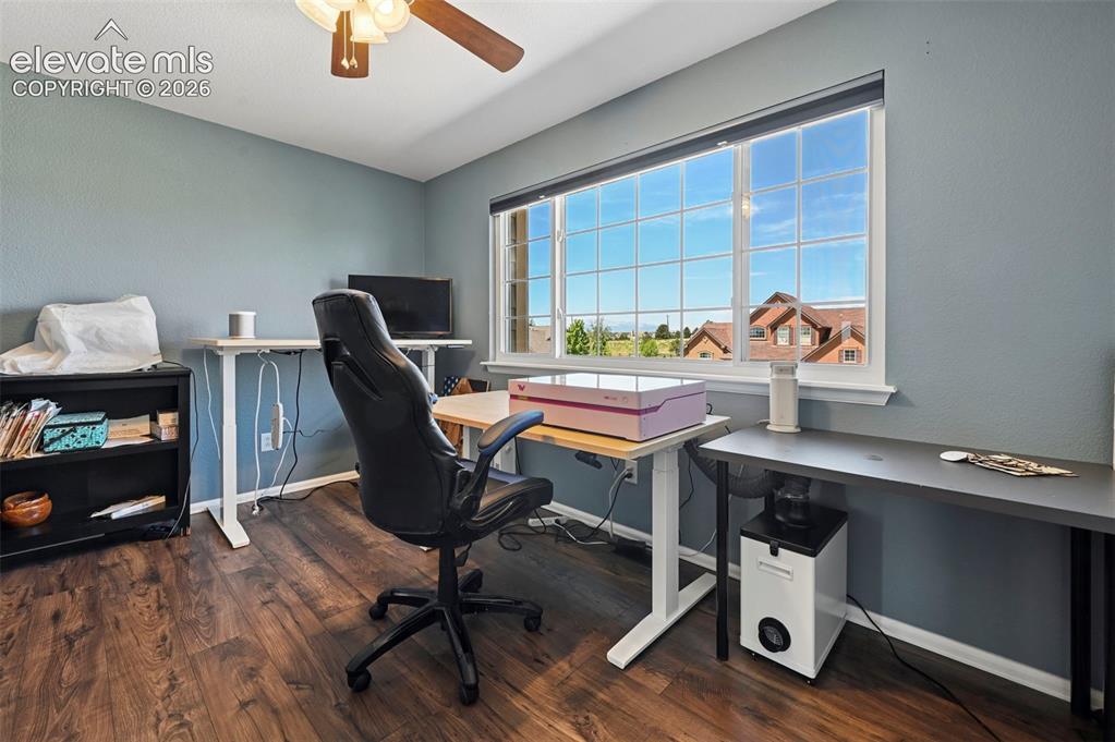 Image 21 of 36: Room featuring wood-finish flooring, a multi-pane window, and a ceiling fan