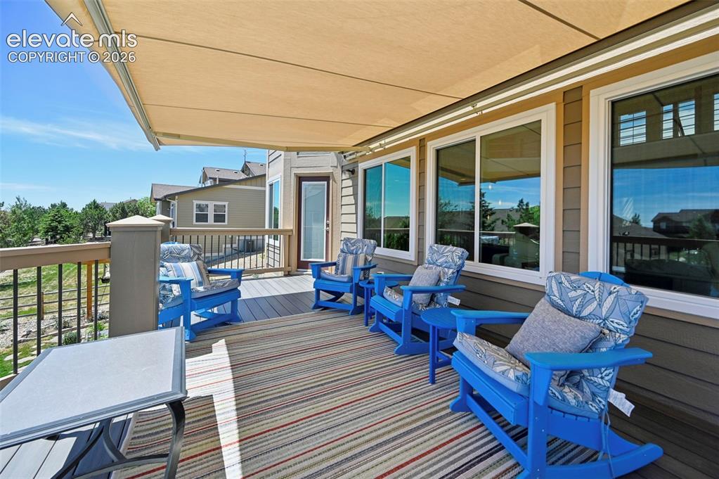 Image 32 of 36: Expansive outdoor deck featuring an automatic retractable awning, composite