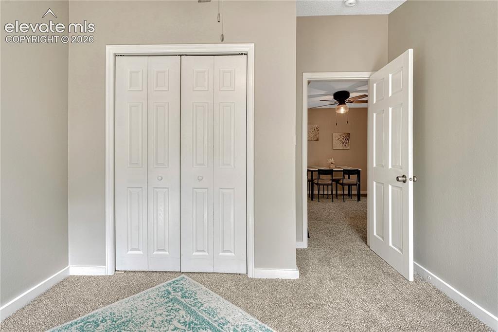 Image 17 of 41: Textured carpeting, white bi-fold closet doors, and light-toned walls