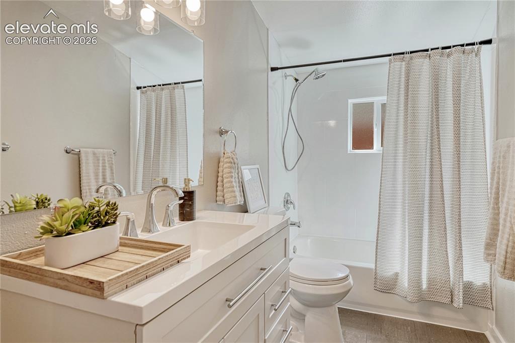 Image 18 of 41: Spa-inspired bathroom featuring a floating vanity with quartz countertop an