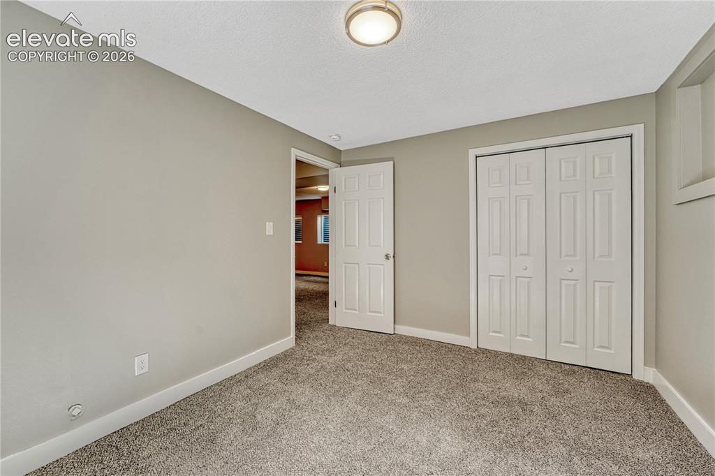 Image 24 of 41: Light gray wall paint, textured ceiling, flush mount ceiling light fixture,