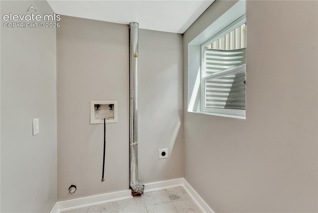 Image 27 of 41: Utility space featuring a window, light gray wall paint, and resilient floo