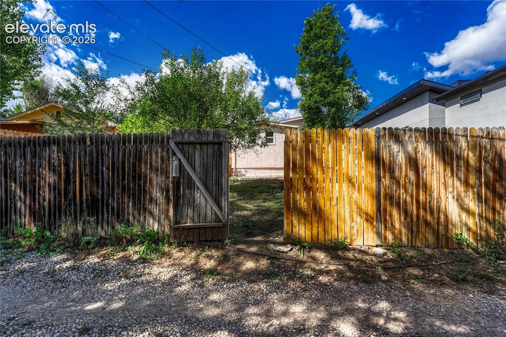 Image 33 of 41: Wood picket fence with a functional gate providing access to the property