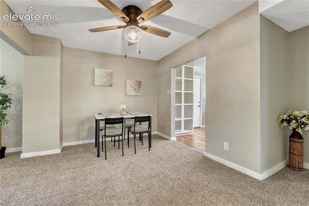 Image 7 of 41: Neutral wall paint, ceiling fan with light fixture, carpet flooring, basebo