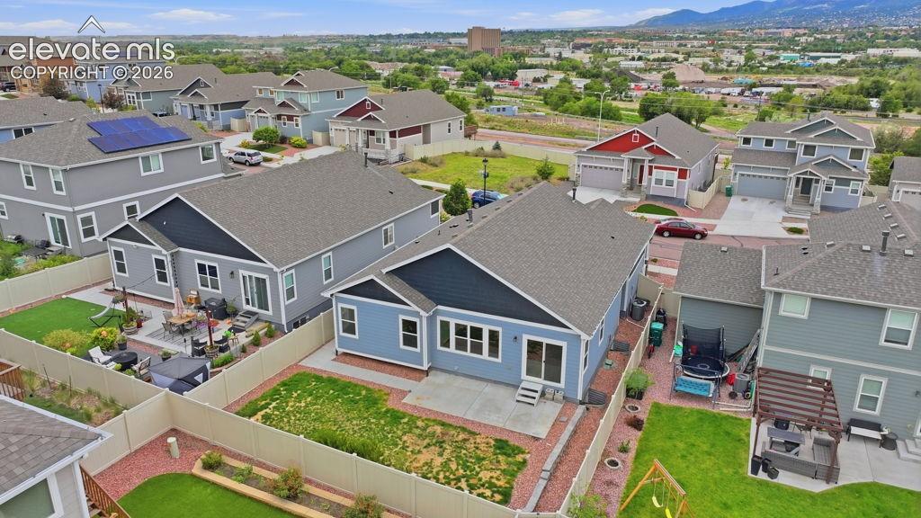 Image 37 of 40: Spacious backyard with a paver patio and ample lawn space