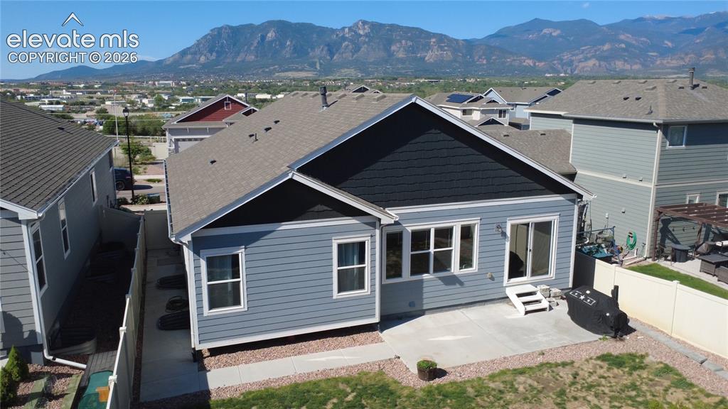 Image 38 of 40: Rear exterior with light blue horizontal siding and dark blue shake siding