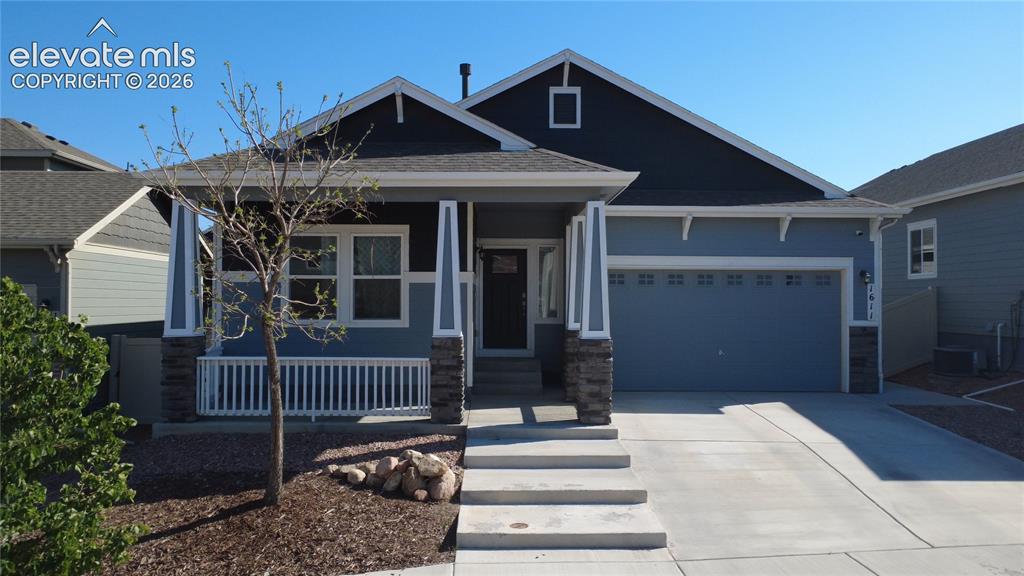Image 40 of 40: Contemporary single-story residence featuring a covered front porch with st