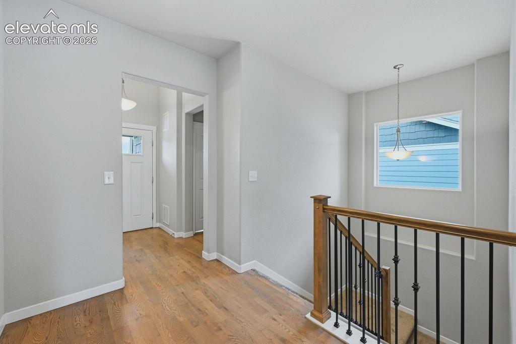 Image 5 of 40: Entryway featuring wood-finish flooring, white trim, and light gray walls