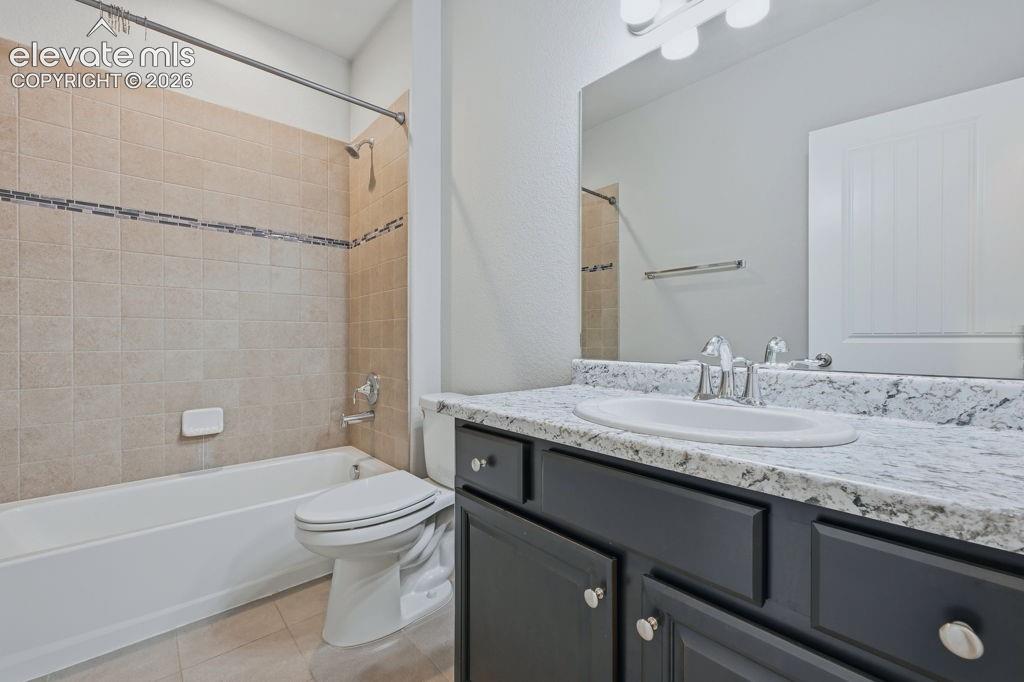 Image 8 of 40: Bathroom featuring a dark vanity with cabinet storage, a white countertop w