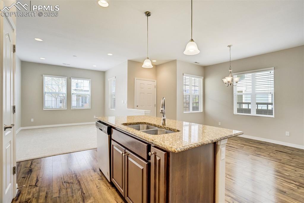 Image 12 of 35: Kitchen with brand new stainless steel appliances, an island with sink, pen