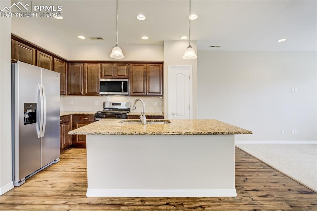 Image 13 of 35: KKitchen with brand new stainless steel appliances, an island with sink, pe
