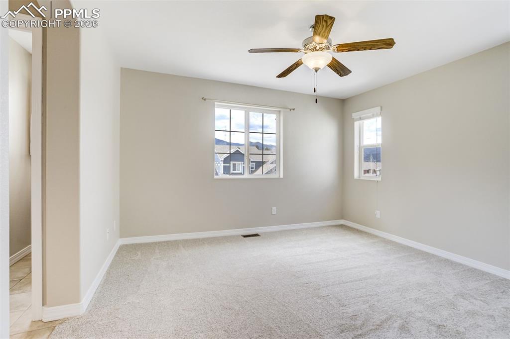 Image 20 of 35: Primary bedroom with ensuite bath, walk-in closet and mountain views