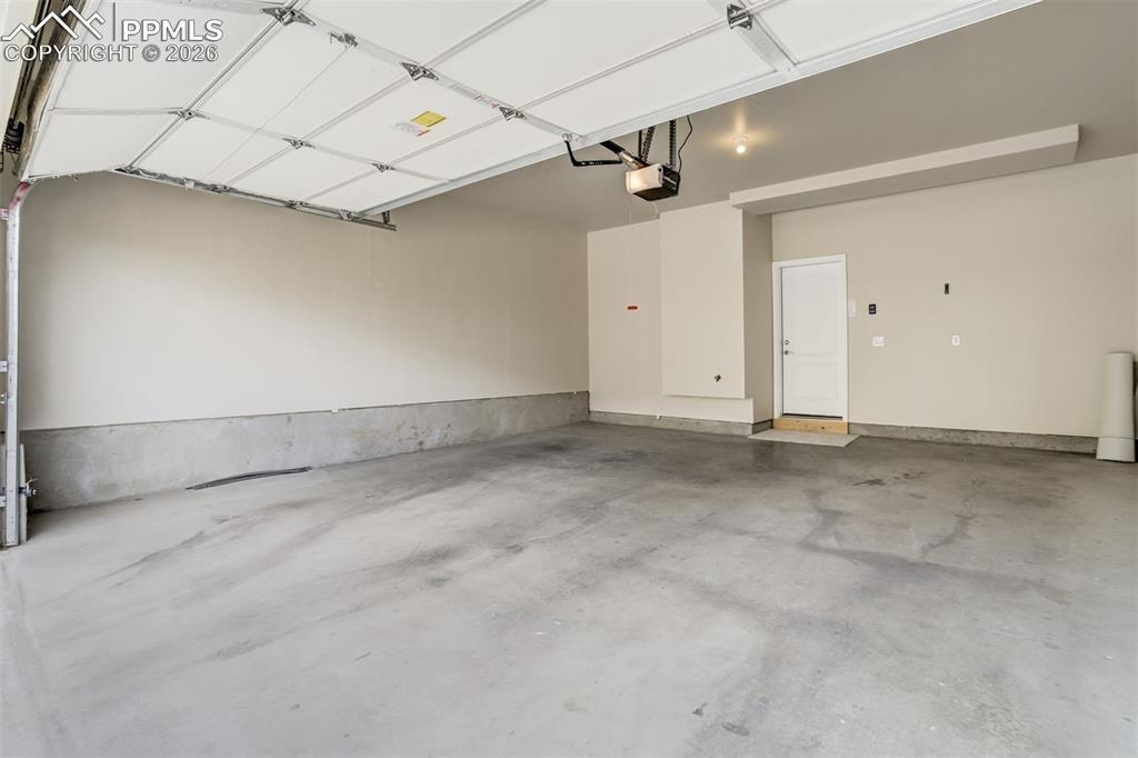 Image 34 of 35: View of oversized 2 car garage with full driveway.