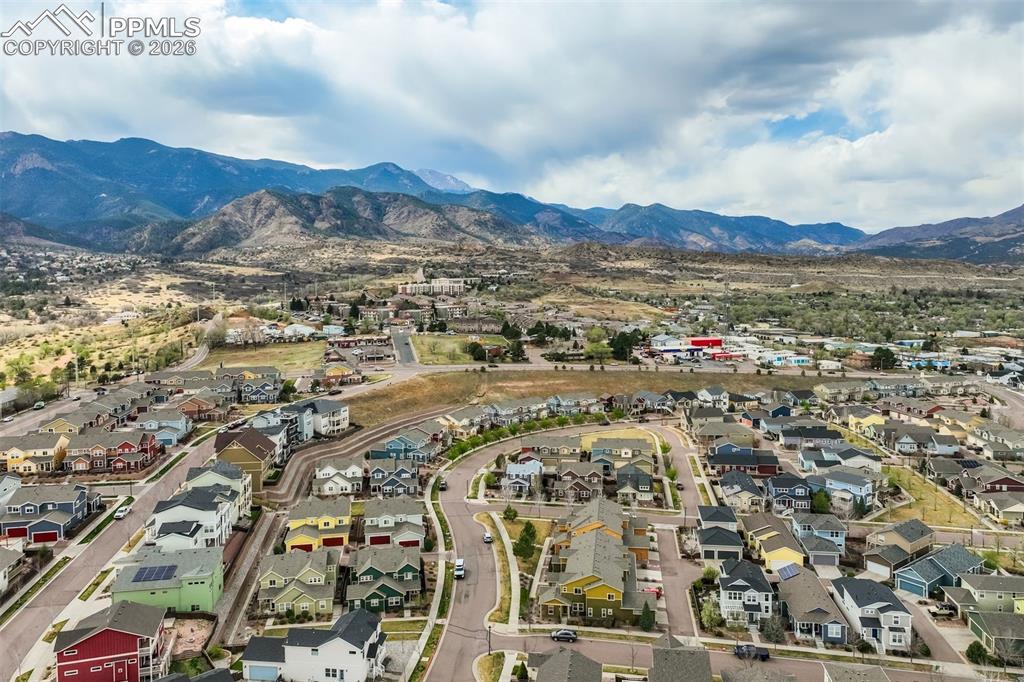 Image 4 of 35: Aerial view of residential area with a mountainous background