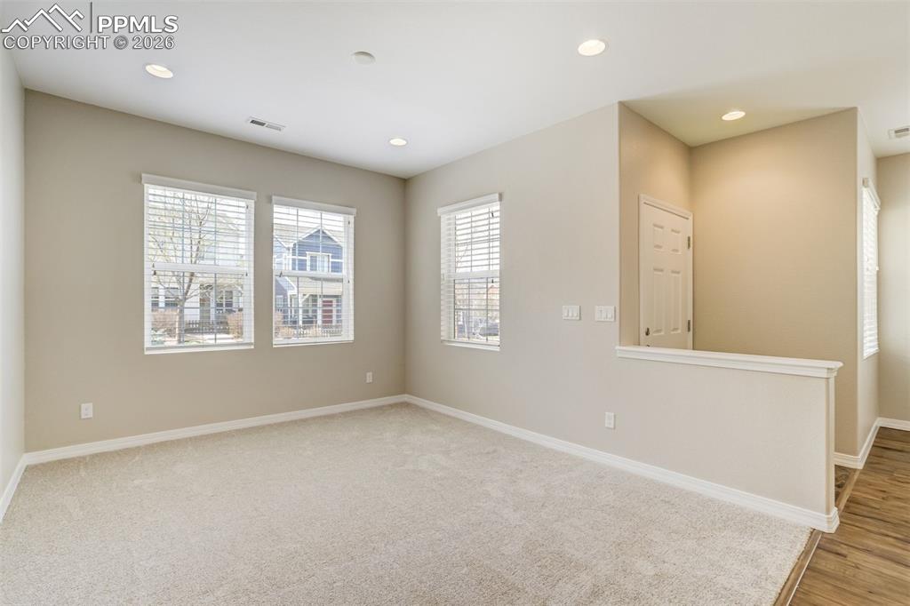 Image 7 of 35: Living room featuring recessed lighting and brand new carpet and pad.