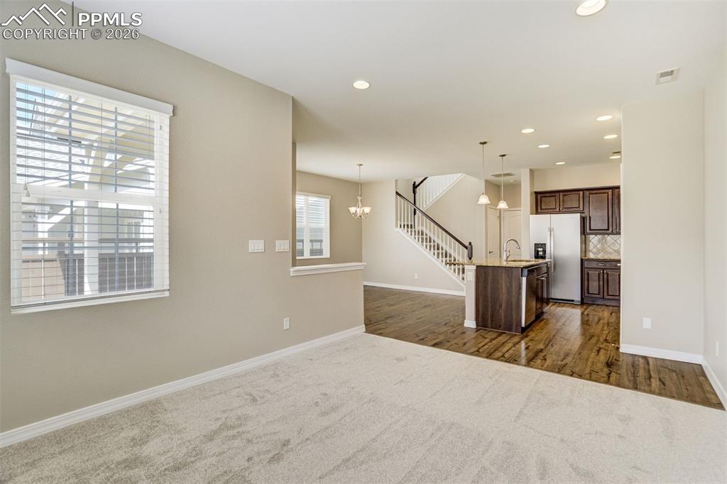 Image 8 of 35: Living room featuring recessed lighting and brand new carpet and pad.