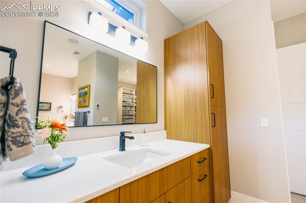 Image 17 of 49: Full bath with vanity and baseboards