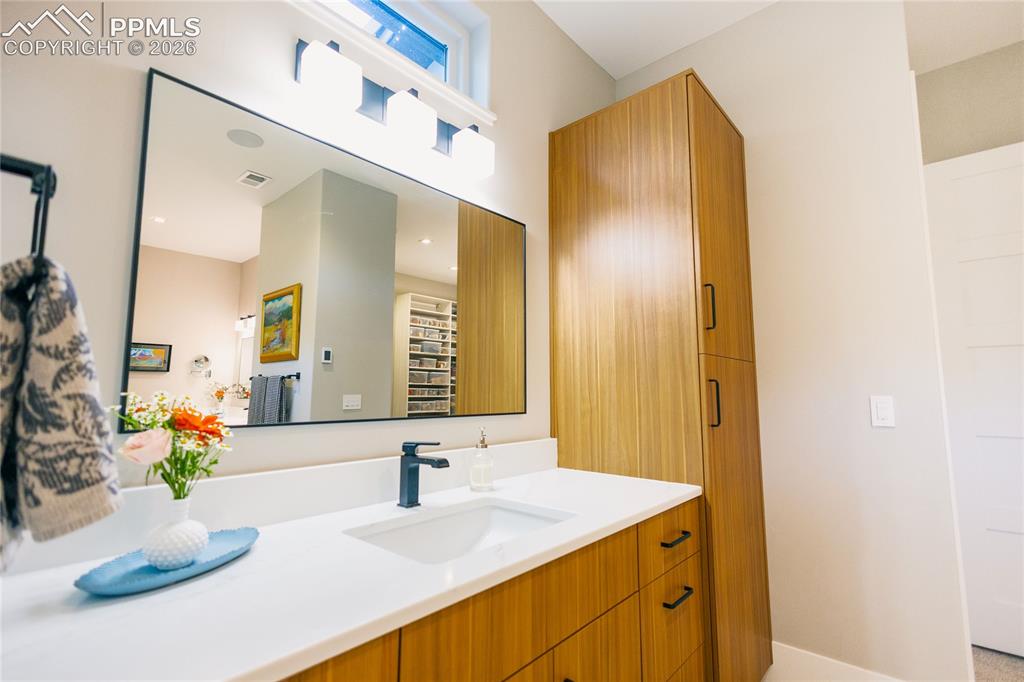 Image 17 of 49: Full bath with vanity and baseboards