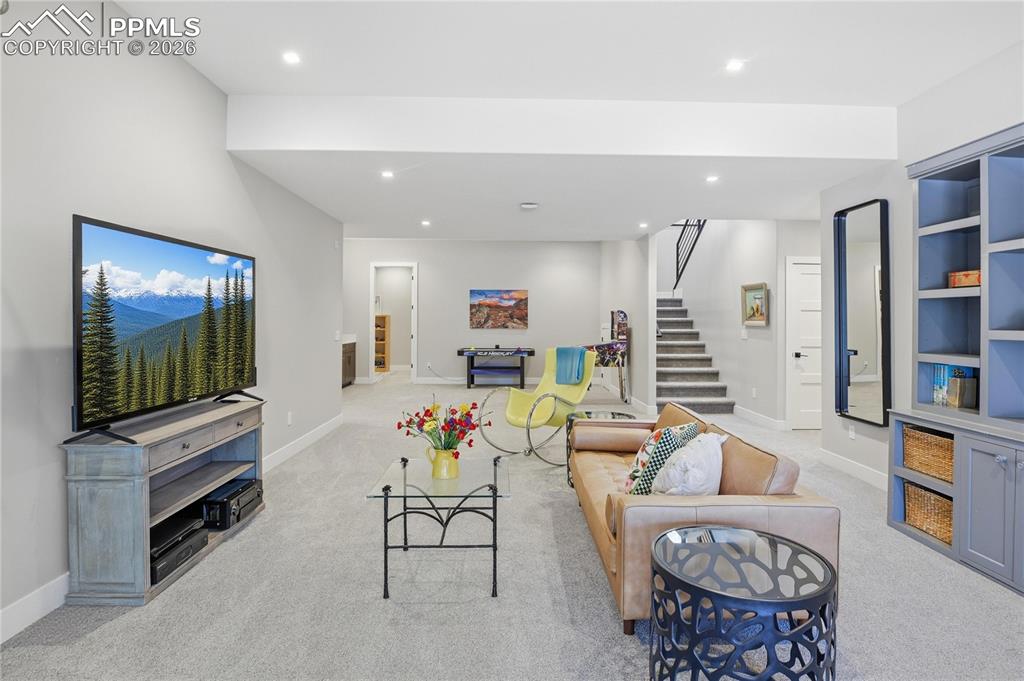 Image 28 of 49: Living area featuring recessed lighting and light carpet