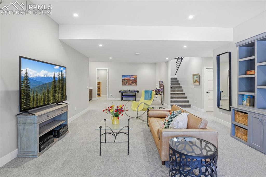 Image 28 of 49: Living area featuring recessed lighting and light carpet