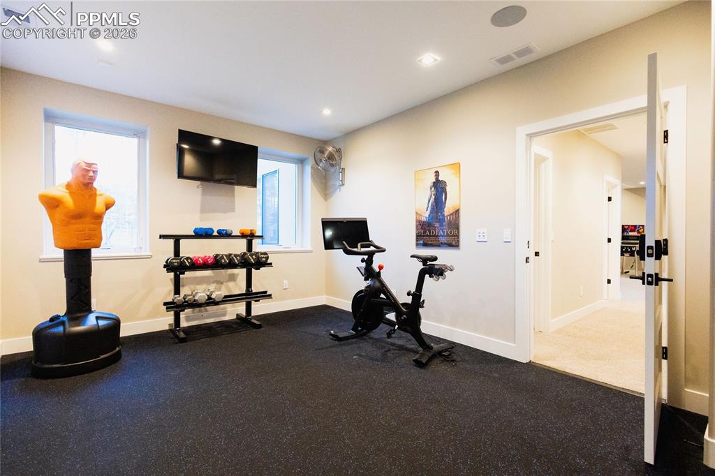 Image 35 of 49: Workout room featuring baseboards and recessed lighting