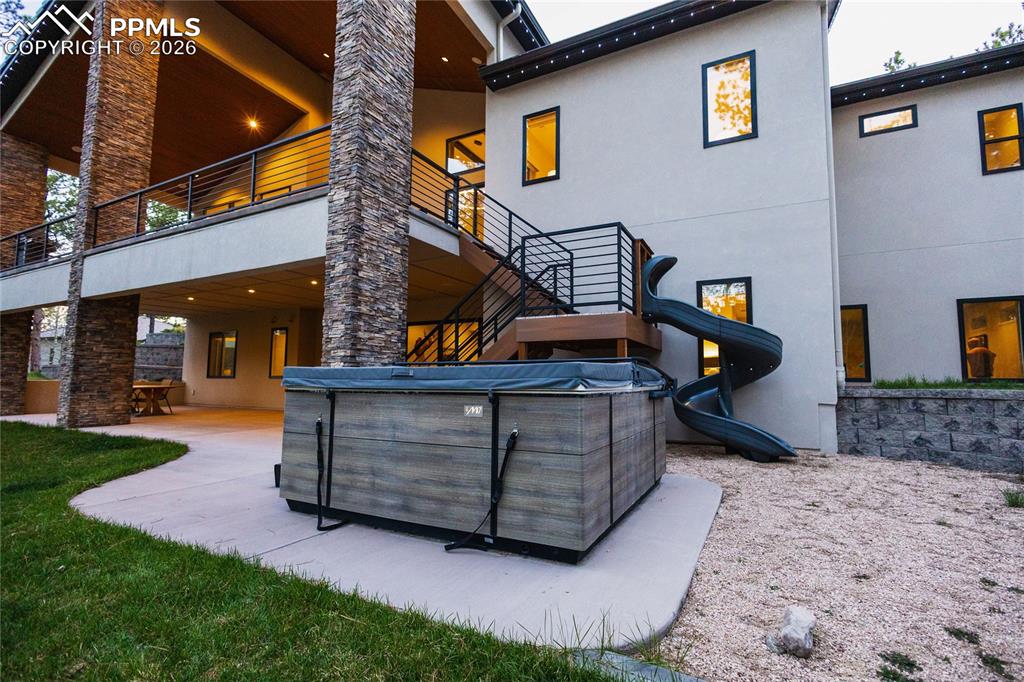Image 42 of 49: Back of property featuring stucco siding, a patio area, and a balcony