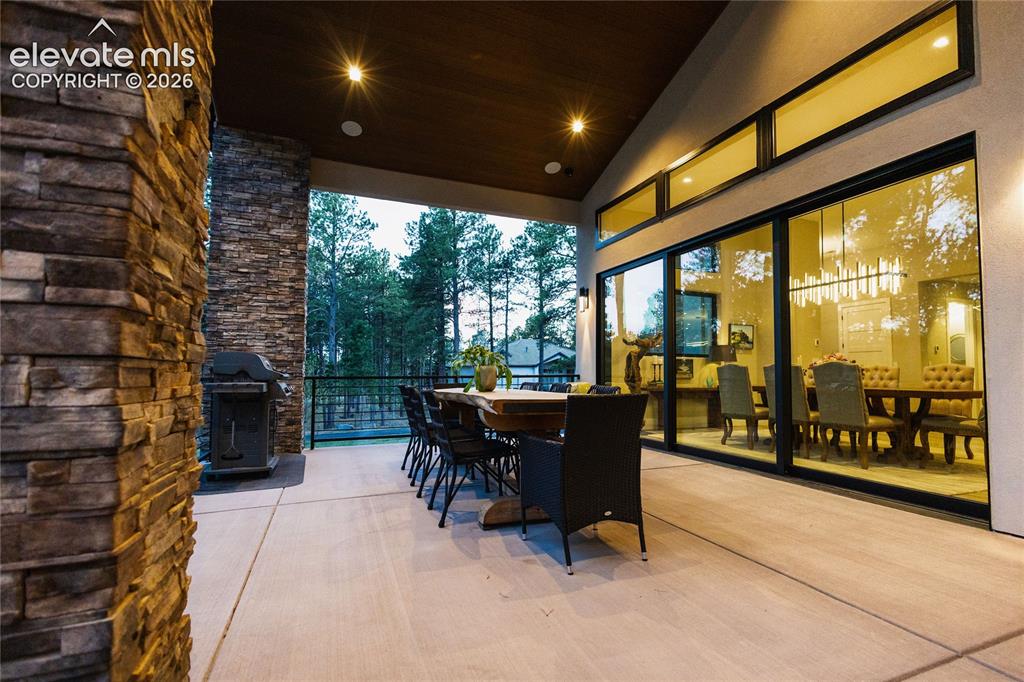 Image 42 of 49: View of patio featuring outdoor dining area and grilling area