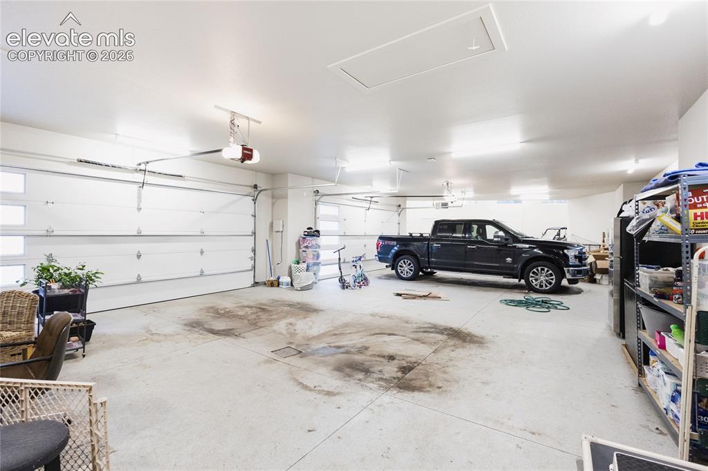 Image 46 of 49: Garage featuring a garage door opener
