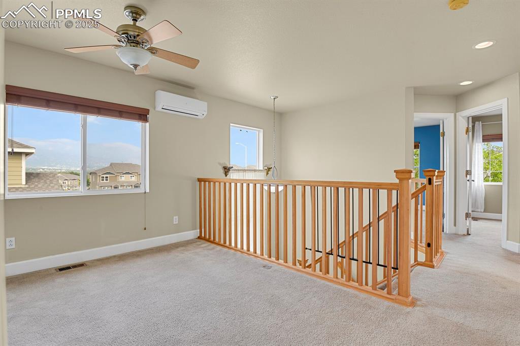 Image 25 of 35: Unfurnished room with carpet, a ceiling fan, recessed lighting, and a wall