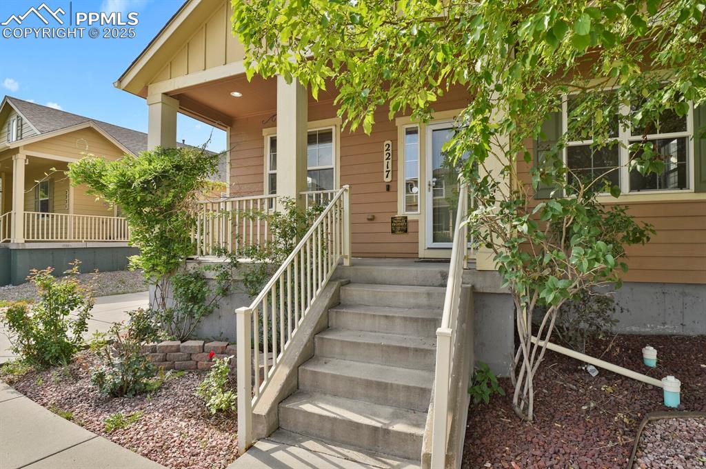 Image 4 of 35: Doorway to property featuring a porch and board and batten siding