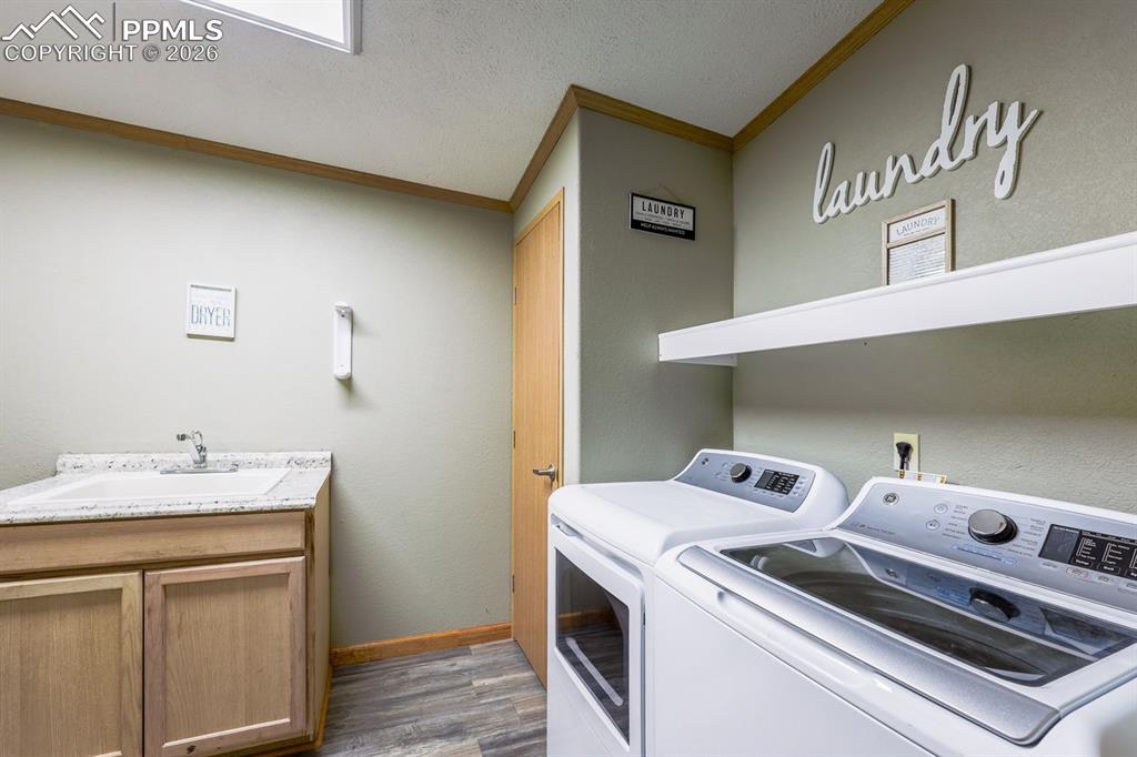 Image 24 of 39: Laundry with sink and storage!