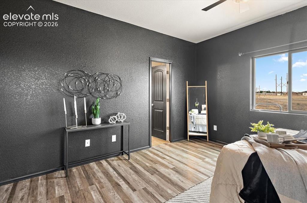Image 18 of 40: Main floor primary bedroom suite, new LVP, newly painted, windows face back