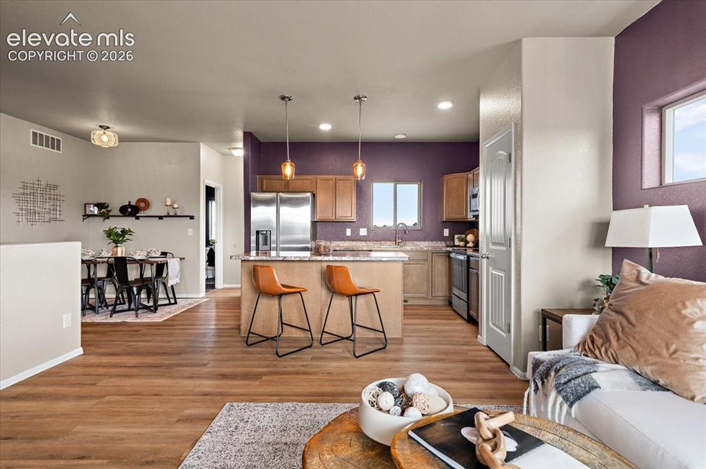 Image 7 of 40: Open floor plan, new LVP, new light fixtures, new paint