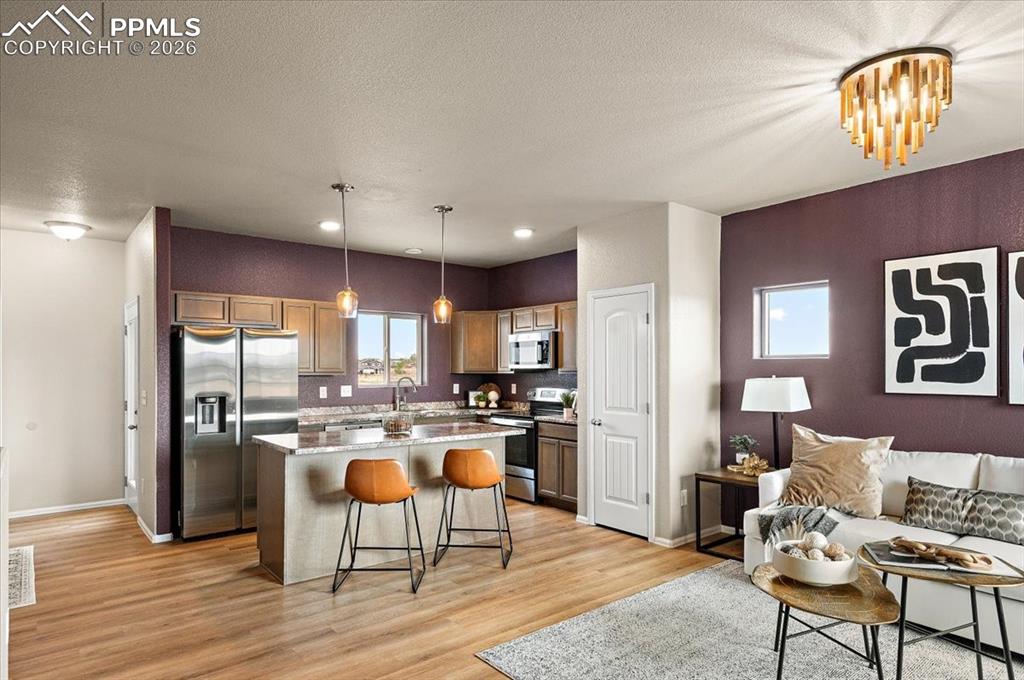 Image 8 of 41: Open floor plan, new LVP, new light fixtures, new paint