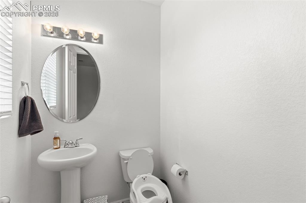 Image 12 of 36: Main level half bathroom