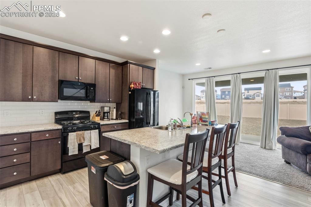 Image 9 of 36: The kitchen features abundant cabinetry for storage and an island counterop