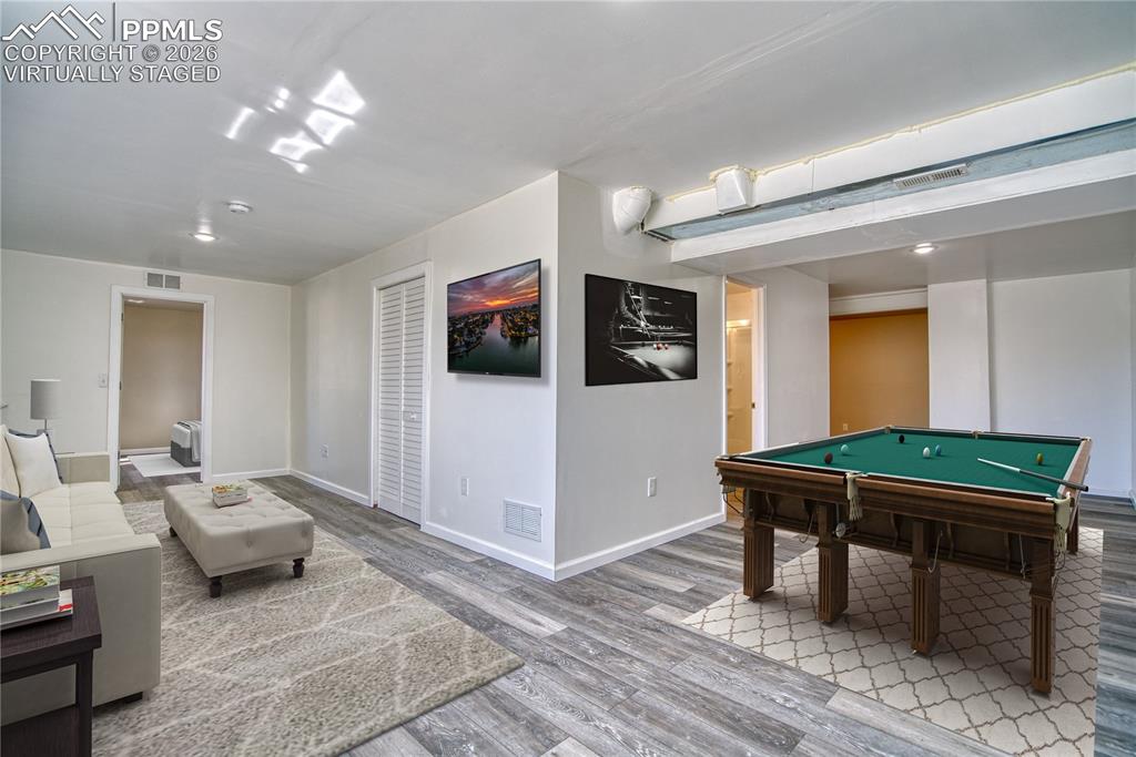 Image 34 of 46: Family Room in basement - virtually staged