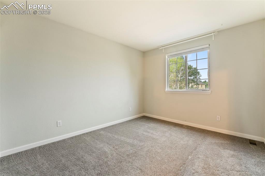 Image 15 of 31: Carpeted spare room featuring baseboards