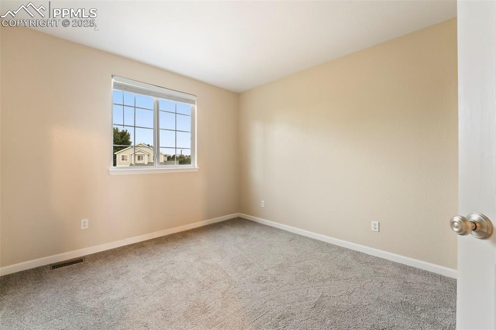 Image 17 of 31: Carpeted empty room featuring baseboards