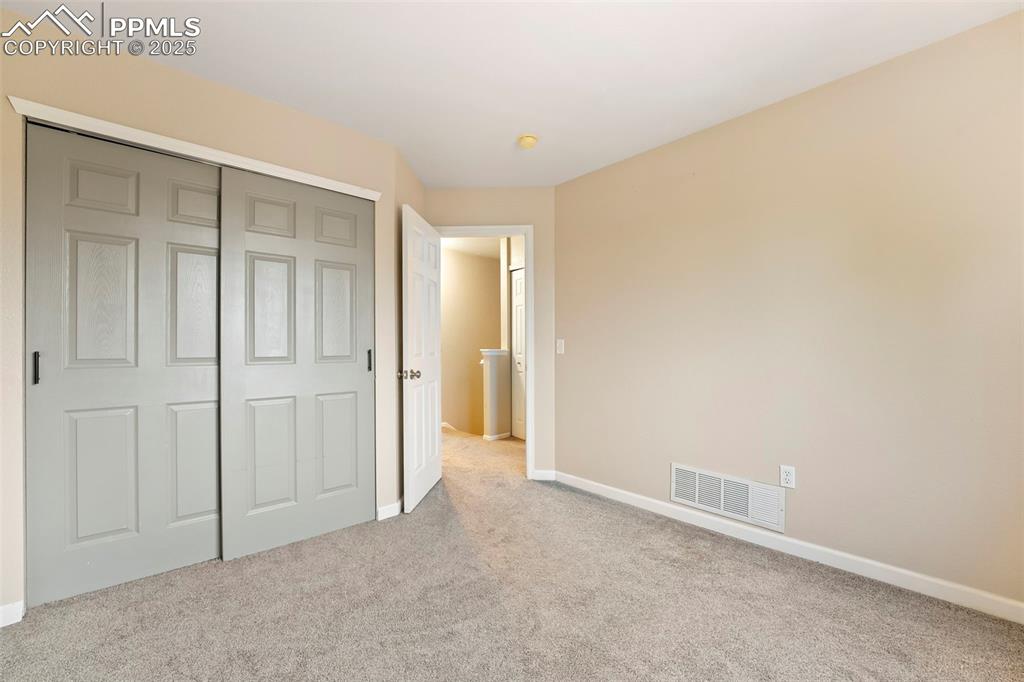 Image 18 of 31: Unfurnished bedroom with carpet flooring and a closet
