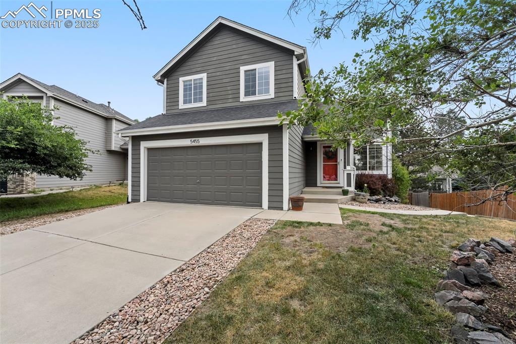 Image 3 of 31: Traditional-style house with an attached garage, driveway, and a shingled r