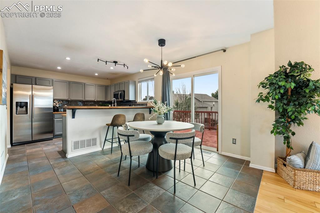 Image 5 of 31: Dining area with a chandelier and recessed lighting