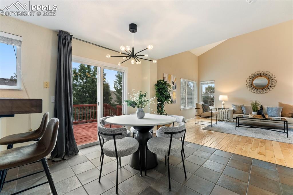 Image 6 of 31: Dining space with a chandelier, tile patterned floors, plenty of natural li